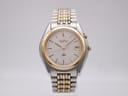 Front view of the Seiko Kinetic 5M42-0B80 two-tone watch with a white dial, gold baton indices, and a date window at 3 o'clock.