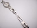 Top-down view of the integrated stainless steel bracelet and signed Seiko deployant clasp.
