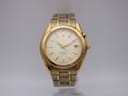 Front view of a gold-tone Seiko Kinetic watch with a champagne dial and gold baton indices.