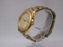 Angled side view of the gold Seiko Kinetic watch showing the crown and case profile.