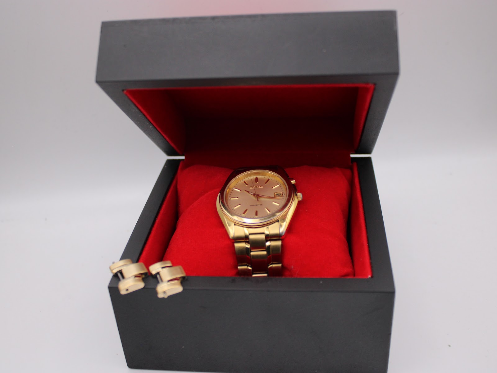 The Seiko Kinetic watch displayed open in a black and red presentation box.