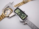 Top-down view of the watch being measured by a digital caliper, displaying a case diameter of 39.64mm.