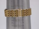 Close-up of the gold-tone steel bracelet and signed Seiko clasp on a wrist sizing gauge, showing a wrist circumference of 198mm.