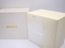 Two parts of the original Seiko watch box, an inner white box with "SEIKO" in gold and an outer white box with "SEIKO" in silver, showing some wear.