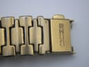 Close-up of the gold-toned bracelet clasp, clearly showing the "SEIKO" logo engraved on it.
