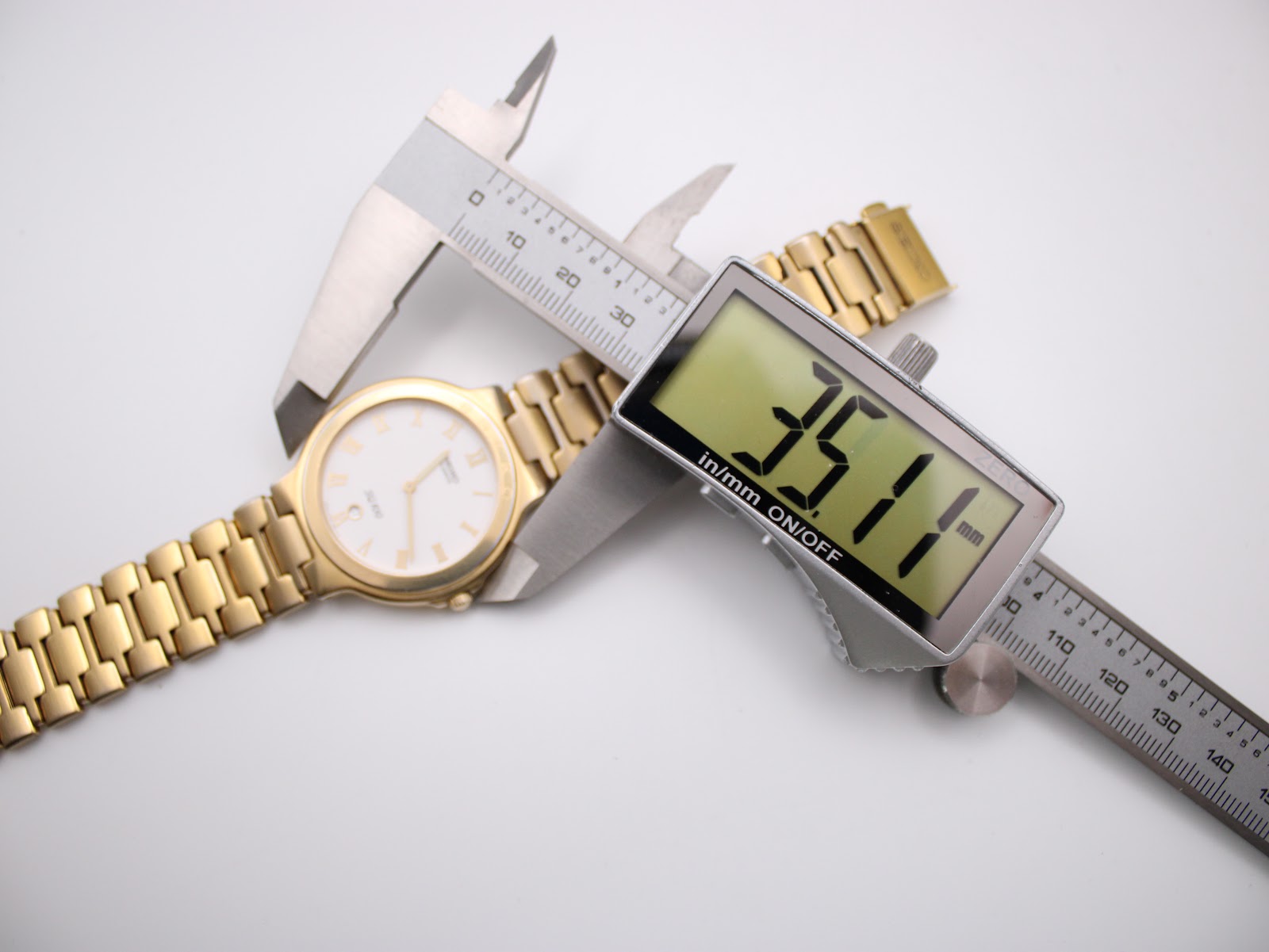 Overhead shot of the watch on a white background with a digital caliper measuring the case diameter at 35.1mm.