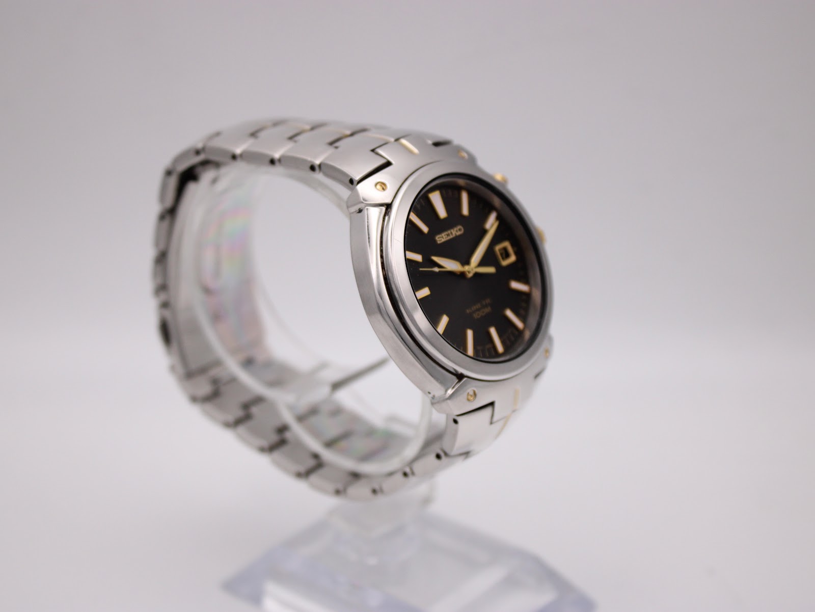 Another angled side view of the Seiko watch highlighting the gold-tone crown and pusher.