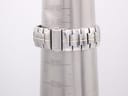 Rear view of the two-tone stainless steel bracelet on a wrist sizing gauge, showing the signed Seiko clasp.