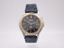 Front view of two-tone Seiko Kinetic watch with navy blue dial and embossed leather strap.
