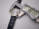 Digital caliper measuring the case diameter of the Seiko Kinetic watch at 38.17mm from a top-down angle, showing the full dial.