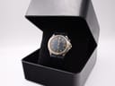 Seiko Kinetic watch with navy dial and leather strap displayed in a plain black presentation box.