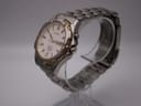 Three-quarter angled view of the Seiko Kinetic watch on a display stand, highlighting the two-tone titanium case and integrated bracelet.