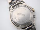 Close-up of the Seiko titanium case back, engraved with "Sapphlex Crystal", "Water Resistant 10 BAR", "Titanium", and model number 5M63-0C10.