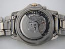 Detailed shot of the Seiko 5M63A Kinetic movement visible through the open case back, showing the oscillating rotor and gear train.