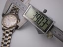 Digital caliper measuring the case diameter of the Seiko watch precisely, displaying a reading of 39.03mm.