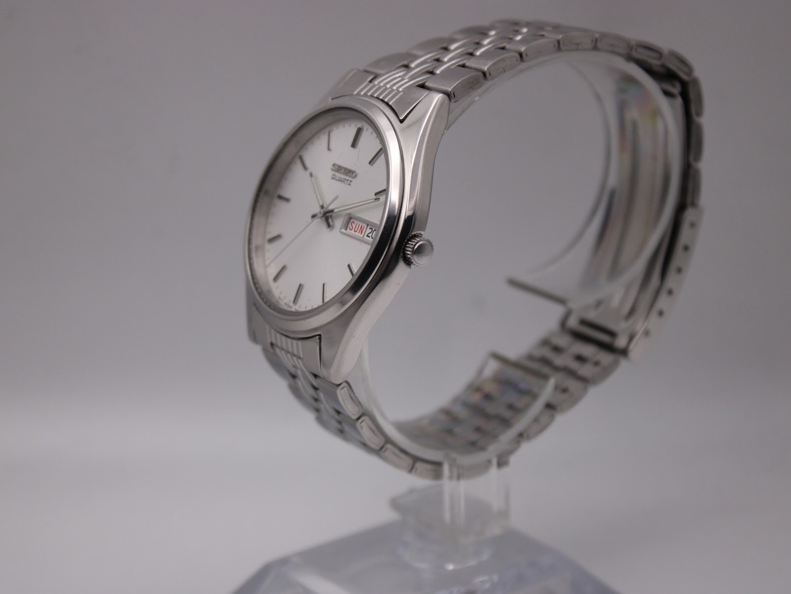 Angled side view of the Seiko watch, showing the case profile and integrated bracelet links.