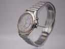Angled side view of the Seiko Kinetic watch showing the polished and brushed case, gold-tone bezel ring, and crown.