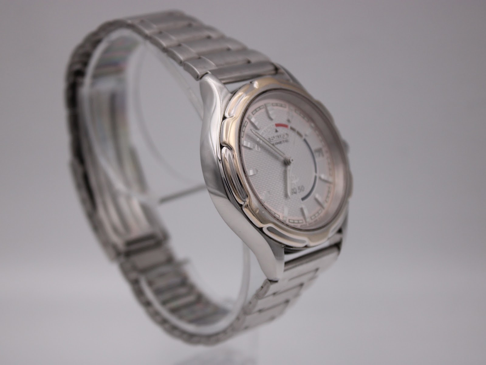 Alternate angled side view of the Seiko watch highlighting the case contours, two-tone details, and integrated bracelet.