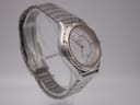 Alternate angled side view of the Seiko watch highlighting the case contours, two-tone details, and integrated bracelet.