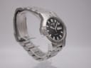Angled left side view of the Seiko kinetic watch on a display stand, highlighting the unique case shape and bracelet.