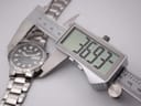 Digital caliper measuring the watch case diameter, displaying 36.93mm.