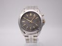 Front view of Seiko 5M62-0AV0 kinetic watch with dark grey dial and two-tone bracelet.