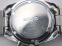 Close-up of the stainless steel case back, engraved with 'SEIKO', 'WATER RESISTANT 5 BAR', '5M62-0AV0', and serial '120001'.