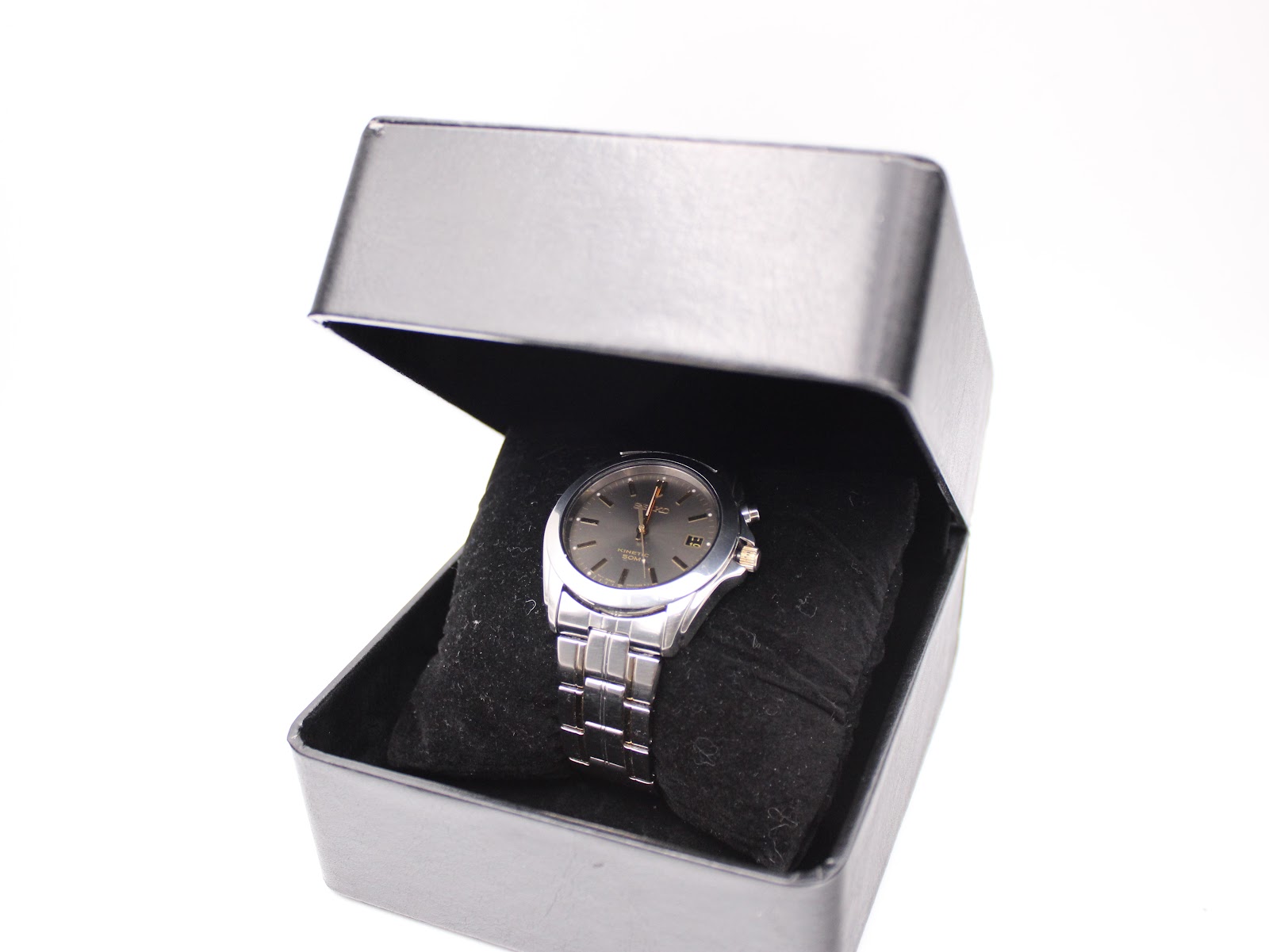 The Seiko 5M62-0AV0 watch nestled inside a generic black presentation box.