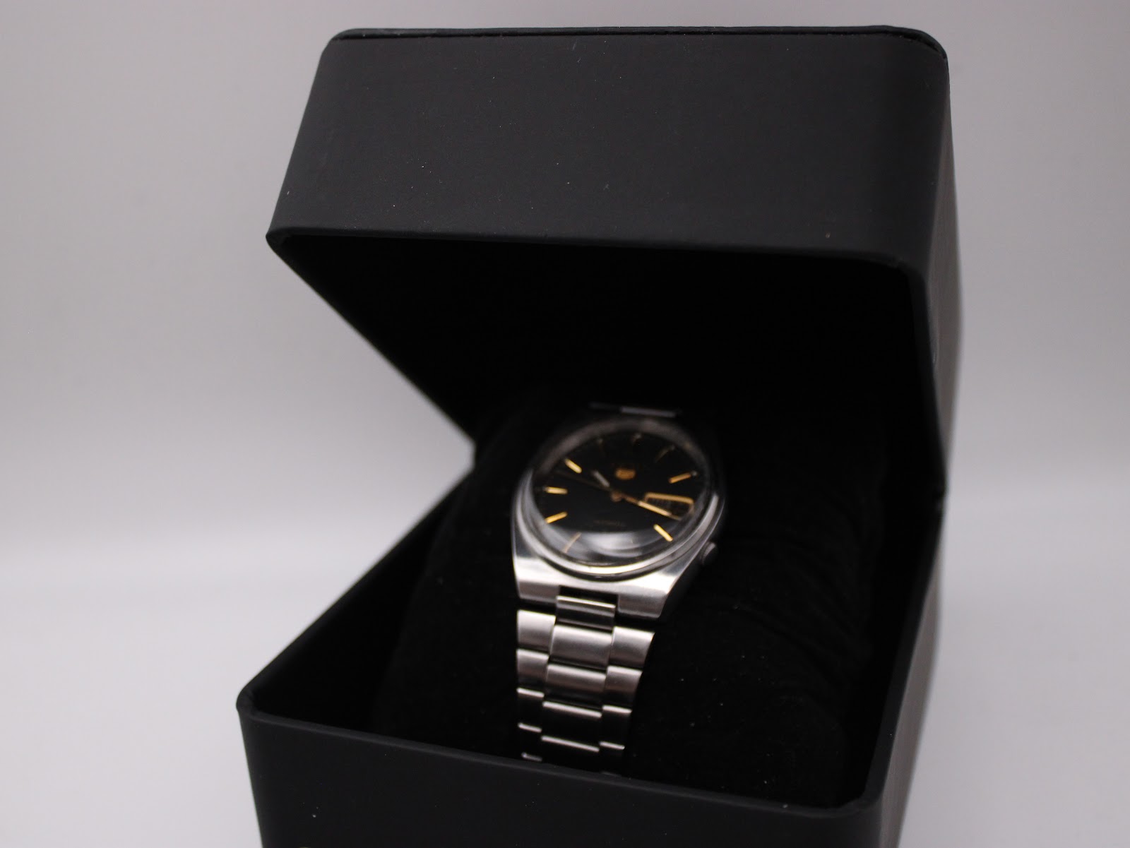 The Seiko watch presented in a generic black watch box, offering a general view of its appearance.