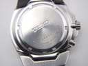 Close-up of the brushed stainless steel case back with Seiko branding, serial number 8D0658, and water resistance rating.