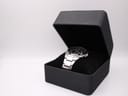 The Seiko Kinetic watch resting on a cushion inside a black presentation box, viewed from an angle.