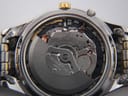Close-up view of the Seiko 5M82A Kinetic movement inside the open case, showing the rotor and internal mechanics.