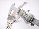 Digital caliper measuring the case diameter of the Seiko watch, showing a precise reading of 37.8mm.