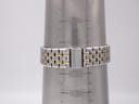 Close-up of the two-tone stainless steel bracelet with signed Seiko deployant clasp on a wrist sizing cone, indicating approximate wrist circumference.