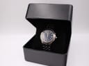 Seiko Kinetic watch displayed inside a generic black presentation box, angled shot.