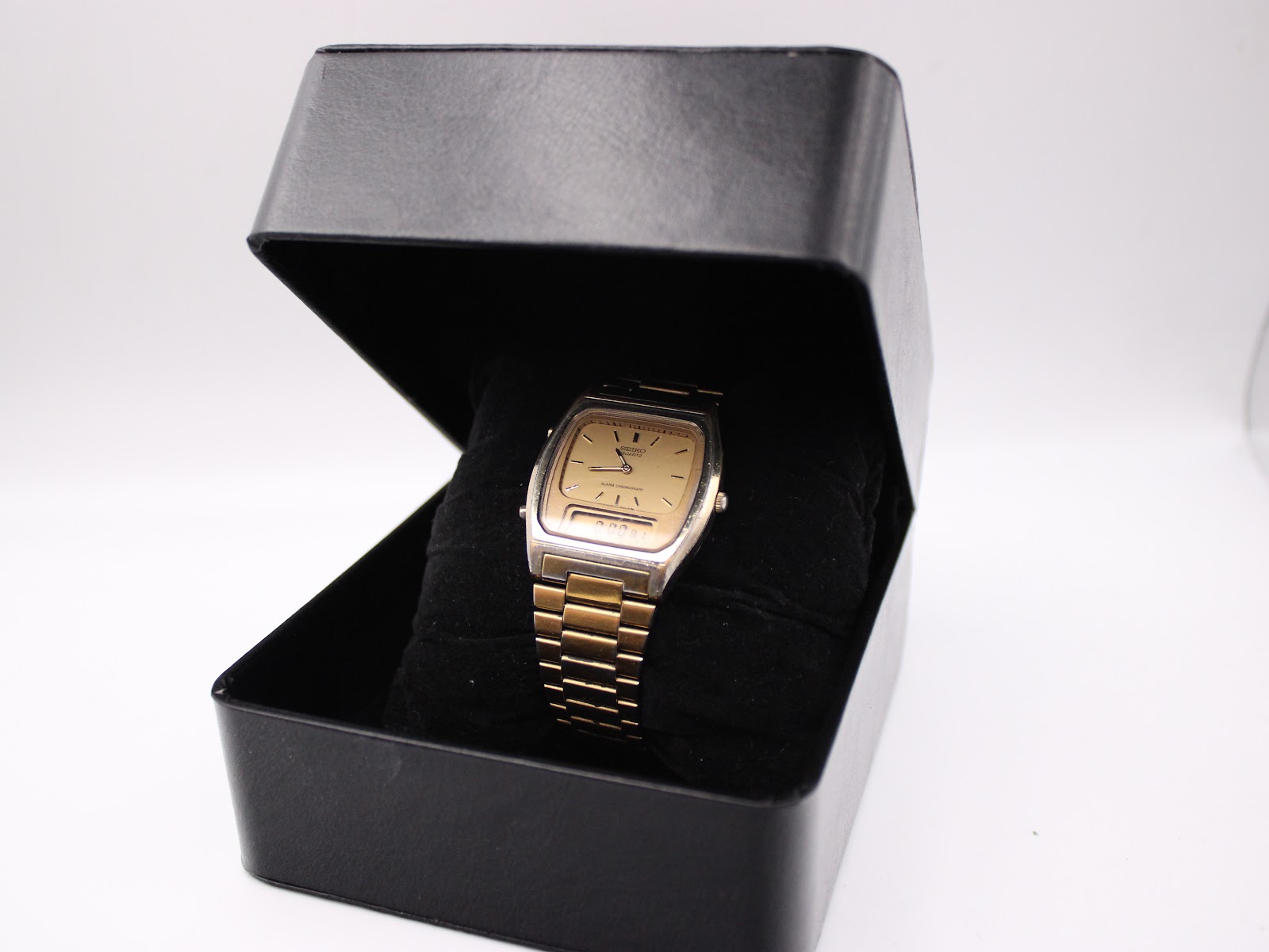 The SEIKO watch presented inside a generic black watch box.