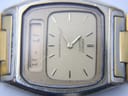 Extreme close-up of the champagne dial and digital display, revealing some scratches on the crystal surface.
