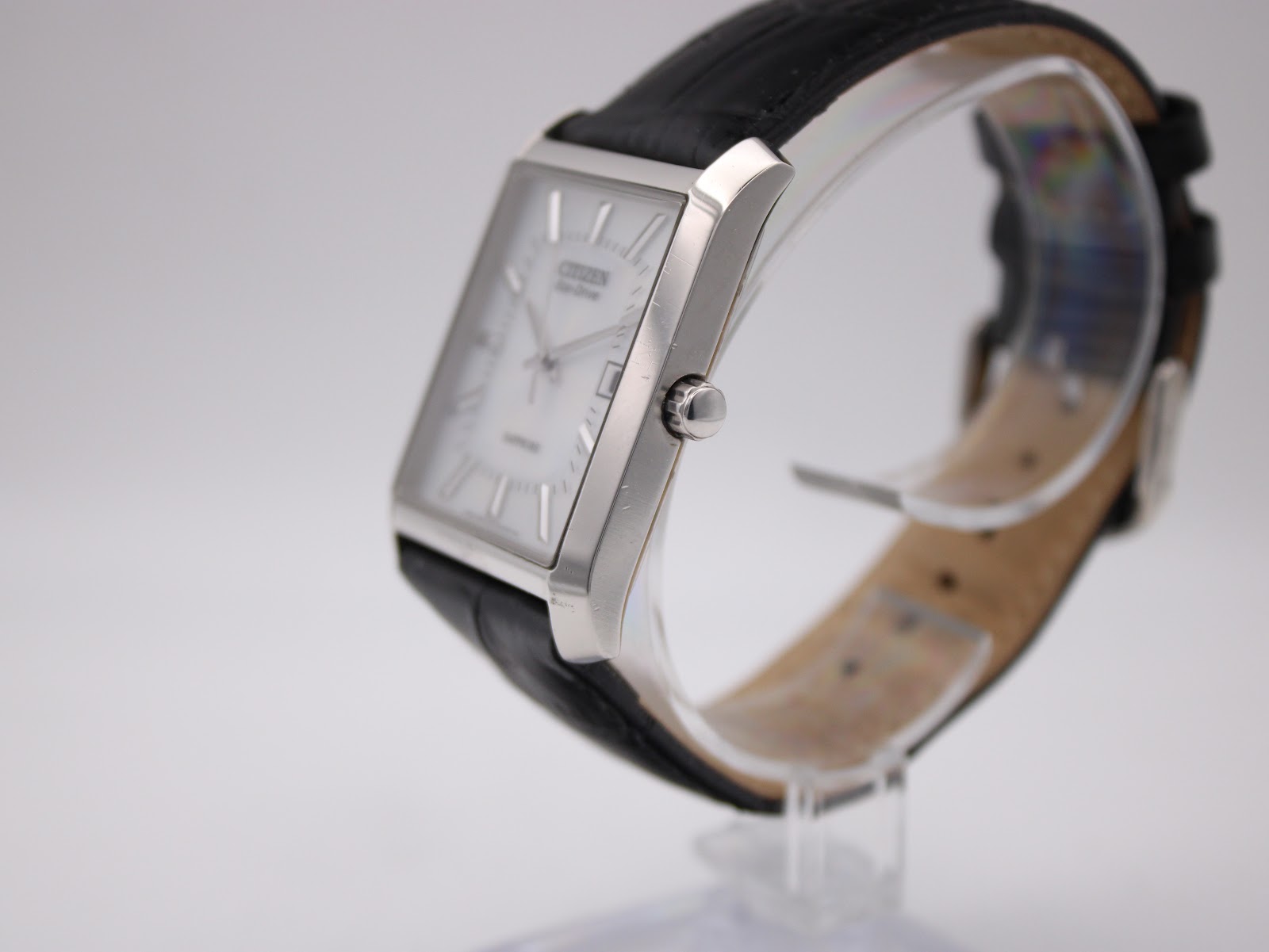 Side view of the Citizen Eco-Drive watch on a display stand, highlighting the polished silver case and crown.