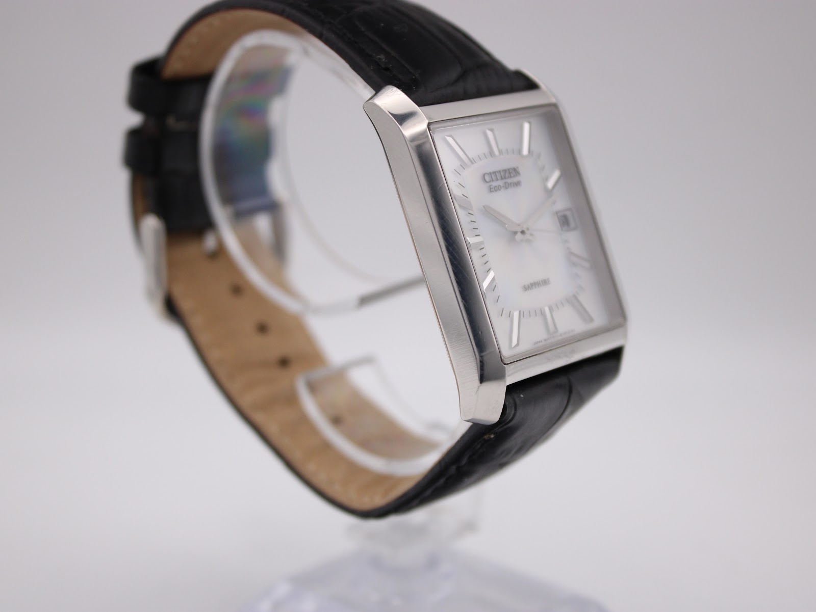 Another angled side view of the Citizen Eco-Drive watch, showcasing the case profile and black leather strap.