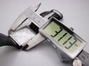 Close-up of a digital caliper measuring the width of the Citizen watch case, displaying 31.37 mm.