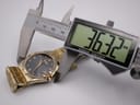 Digital caliper measuring the Citizen Eco-Drive watch case, displaying 36.32mm.