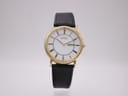Frontal view of the Citizen Eco-Drive watch on a clear stand, showing white dial, gold case, and black leather strap.