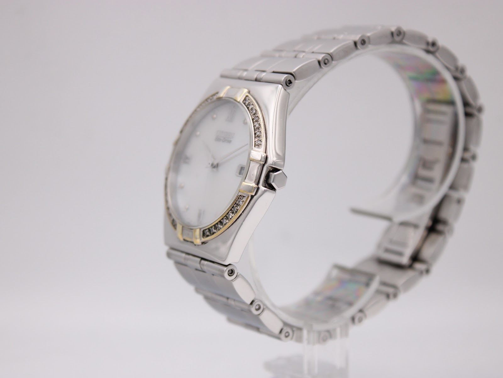 Side profile view of the Citizen Eco-Drive watch on a display stand, highlighting the case shape and integrated bracelet.