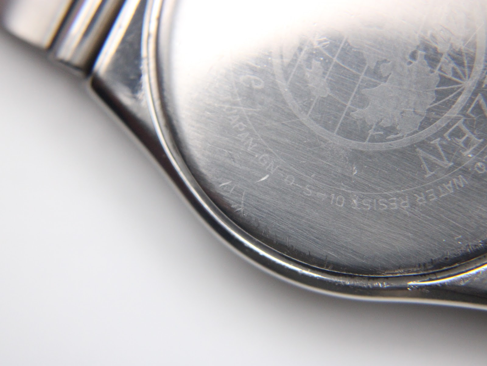 Close-up of the Citizen watch case back, showing 'CITIZEN WATCH CO. WATER RESIST JAPAN' engraving.