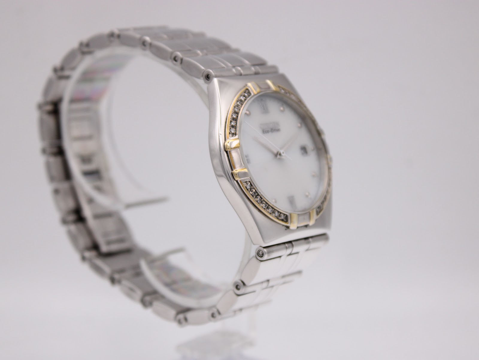 Three-quarter view of the Citizen Eco-Drive watch on a display stand, showcasing its two-tone design.