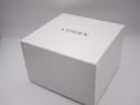 External view of the closed original white Citizen watch box with the brand name printed on top.