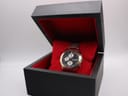 Citizen two-tone chronograph watch displayed in its open original black box with red interior.