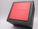 Top view of the closed original black Citizen watch box with an embossed red central panel.