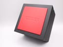Top view of the closed original Citizen watch box, black with an embossed red lid.