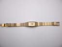 Full overhead view of the Citizen watch with its gold-tone textured bracelet laid flat, showing the front.